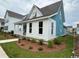 Exterior home view showcasing the home's blue siding and trim with manicured landscaping at 734 Macon Alley, Myrtle Beach, SC 29588