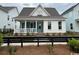 Quaint single-Gathering home with a charming front porch and stylish black fencing at 734 Macon Alley, Myrtle Beach, SC 29588