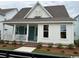 Attractive home with a welcoming porch, a combination of white and blue siding, and manicured landscaping at 734 Macon Alley, Myrtle Beach, SC 29588