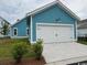 Detached garage with a clean, white door, blue siding, and well-kept landscaping at 734 Macon Alley, Myrtle Beach, SC 29588