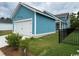 Detached garage with a white door, blue siding, and a neat, well-maintained yard at 734 Macon Alley, Myrtle Beach, SC 29588