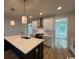 Stylish kitchen boasts an island with sink, pendant lights, and white cabinets for a modern feel at 734 Macon Alley, Myrtle Beach, SC 29588