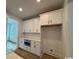 Well-lit kitchen with white cabinets, stainless steel appliances, and tile backsplash detail at 734 Macon Alley, Myrtle Beach, SC 29588