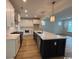 Elegant kitchen with large island, stainless steel appliances, pendant lighting, and modern finishes at 734 Macon Alley, Myrtle Beach, SC 29588