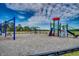 A colorful community playground with slides, swings, and climbing structures, set in a mulch-covered area at 734 Macon Alley, Myrtle Beach, SC 29588