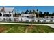 Attractive community pool and splashpad area surrounded by well-maintained green spaces and fencing at 734 Macon Alley, Myrtle Beach, SC 29588