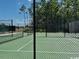An outdoor tennis court with a black fence and trees behind it, offering a great place to play at 734 Macon Alley, Myrtle Beach, SC 29588