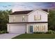 Charming two-story home features a front yard, garage, and a mix of vertical and shake siding at 1008 Maple View Rd., Supply, SC 28462
