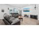 Living room with hardwood floors, couches, and large TV at 2523 Blue Crane Circle # 102, Myrtle Beach, SC 29577