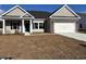 Charming single-story home with neutral siding, brick accents, and a two-car garage at 323 Palmetto Sand Loop, Conway, SC 29527