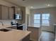 Stylish kitchen with gray cabinets, quartz countertops, and a central island at 323 Palmetto Sand Loop, Conway, SC 29527