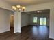 Elegant living room with hardwood floors, chandelier, and ample natural light at 323 Palmetto Sand Loop, Conway, SC 29527