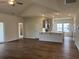 Open-concept living room and kitchen area with hardwood floors and modern finishes at 323 Palmetto Sand Loop, Conway, SC 29527