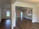 Spacious living room featuring hardwood floors, neutral walls, and an open layout at 323 Palmetto Sand Loop, Conway, SC 29527