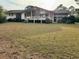 Back exterior view showcasing the spacious backyard with deck overlooking the grassy lawn at 3774 Annandale Dr., Myrtle Beach, SC 29577