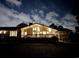Rear exterior of the home, illuminated at night, highlighting the expansive deck and backyard at 3774 Annandale Dr., Myrtle Beach, SC 29577