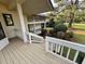 Inviting back porch leads to a lush, landscaped yard with mature trees and garden beds at 3774 Annandale Dr., Myrtle Beach, SC 29577