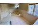 Bathroom features a tub, a corner window, and a door to the shower at 3774 Annandale Dr., Myrtle Beach, SC 29577