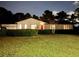 Charming home at twilight featuring a red front door and neatly manicured landscaping providing great curb appeal at 3774 Annandale Dr., Myrtle Beach, SC 29577