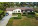 Aerial view of home with lush front lawn, mature landscaping, and an inviting driveway with lake backdrop at 3774 Annandale Dr., Myrtle Beach, SC 29577