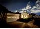 Night view of home showcasing attached garage, beautiful landscaping, and inviting curb appeal at 3774 Annandale Dr., Myrtle Beach, SC 29577