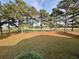 Scenic view of a lush green golf course and pond framed by mature pine trees creating a tranquil backdrop at 3774 Annandale Dr., Myrtle Beach, SC 29577