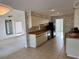 Open kitchen with black appliances, tile floors, and adjacent living space at 3774 Annandale Dr., Myrtle Beach, SC 29577