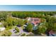 Aerial shot of condos surrounded by trees with a view of multiple parked cars at 4601 Greenbriar Dr. # 205A, Little River, SC 29566