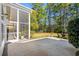 Screened in porch with a large backyard featuring a fountain, tall trees, and green grass at 5012 Lindrick Ct., Myrtle Beach, SC 29579