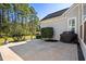 Patio with black grill, fountain, manicured landscaping, and green grass surrounding tall trees at 5012 Lindrick Ct., Myrtle Beach, SC 29579