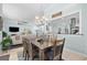 Open-concept dining room with a chandelier, view into kitchen, and seating for six at 5012 Lindrick Ct., Myrtle Beach, SC 29579
