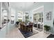 Bright dining area features large windows, sliding glass door, modern chandelier, and neutral tile flooring at 5012 Lindrick Ct., Myrtle Beach, SC 29579