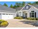 Charming home exterior with attached garage, manicured landscaping, and paved driveway at 5012 Lindrick Ct., Myrtle Beach, SC 29579