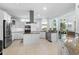 This eat-in kitchen features white cabinetry, stainless appliances, tile floors, and a beautiful countertop at 5012 Lindrick Ct., Myrtle Beach, SC 29579
