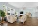 Bright living room with hardwood floors, large windows, and comfortable seating at 5012 Lindrick Ct., Myrtle Beach, SC 29579