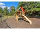 Community playground featuring a climbing wall, slide, and shady seating areas at 5012 Lindrick Ct., Myrtle Beach, SC 29579