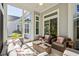 Relaxing screened porch with comfortable seating, coffee table, and ceiling fan at 5012 Lindrick Ct., Myrtle Beach, SC 29579