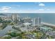 An aerial view shows lush landscaping, convenient parking, and ocean views at 9820 Queensway Blvd. # 1501, Myrtle Beach, SC 29572