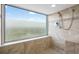 Bright bathroom featuring a shower with neutral tile and a window at 9820 Queensway Blvd. # 1501, Myrtle Beach, SC 29572