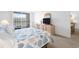 Bright bedroom featuring a queen bed, balcony access, and a dresser with a mounted television at 9820 Queensway Blvd. # 1501, Myrtle Beach, SC 29572
