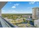 Scenic view from the balcony, showing the community's pond, landscaping, and surrounding buildings at 9820 Queensway Blvd. # 1501, Myrtle Beach, SC 29572