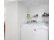Convenient laundry area features a stacked washer and dryer with shelving for storage at 9820 Queensway Blvd. # 1501, Myrtle Beach, SC 29572