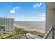 Expansive ocean view from the balcony, showcasing the beach and distant buildings on a sunny day at 9820 Queensway Blvd. # 1501, Myrtle Beach, SC 29572