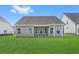 A well-maintained backyard with green grass and the home's exterior, creating an inviting outdoor space at 2412 Campton Loop, Conway, SC 29527