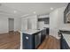 Kitchen view showcasing stainless steel appliances, modern lighting, and the large kitchen island with seating at 2412 Campton Loop, Conway, SC 29527