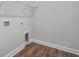 A practical laundry room with wood flooring and a shelf, providing a functional space for chores at 2412 Campton Loop, Conway, SC 29527