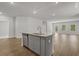 Modern kitchen island with stainless steel dishwasher and sink overlooks the living room space at 2441 Campton Loop, Conway, SC 29527