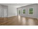 Bright living room with wood-look floors, large windows, and a glass door leading to the yard at 2441 Campton Loop, Conway, SC 29527