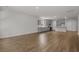 Open-concept living area with wood-look flooring, kitchen in background at 2441 Campton Loop, Conway, SC 29527