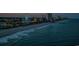 Scenic oceanfront view featuring crashing waves, sandy beach, Ferris wheel, and city skyline at night at 2441 Campton Loop, Conway, SC 29527